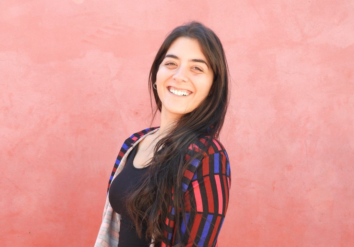 smiling girl in front of red background