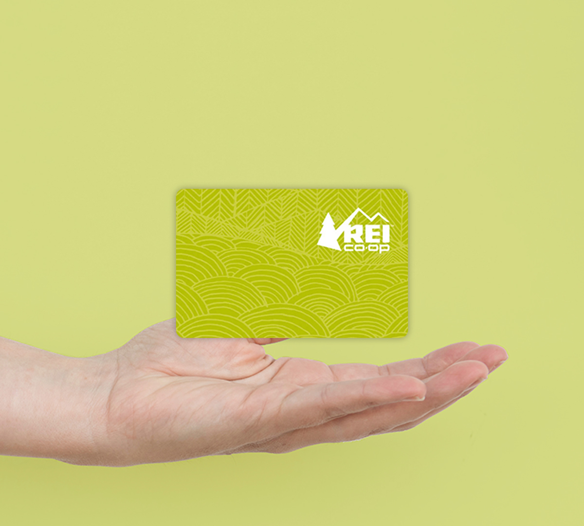 hand holding rei co-op gift card