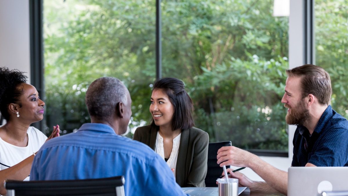 Fight back against The Great Resignation. Group of diverse employees sitting at a conference table.