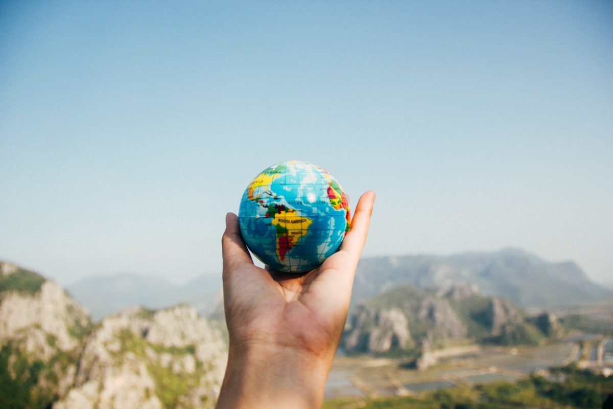 person holding small globe